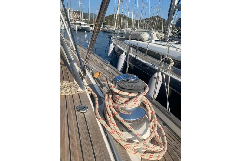  Yacht Photos Pics Deck of 2007 Hallberg-Rassy 54 sailboat with winch and rope, docked in marina.