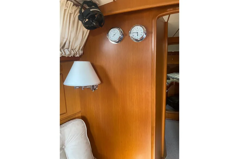 Yacht Photos Pics Interior of 2007 Hallberg-Rassy 54 yacht with wood paneling and nautical instruments.