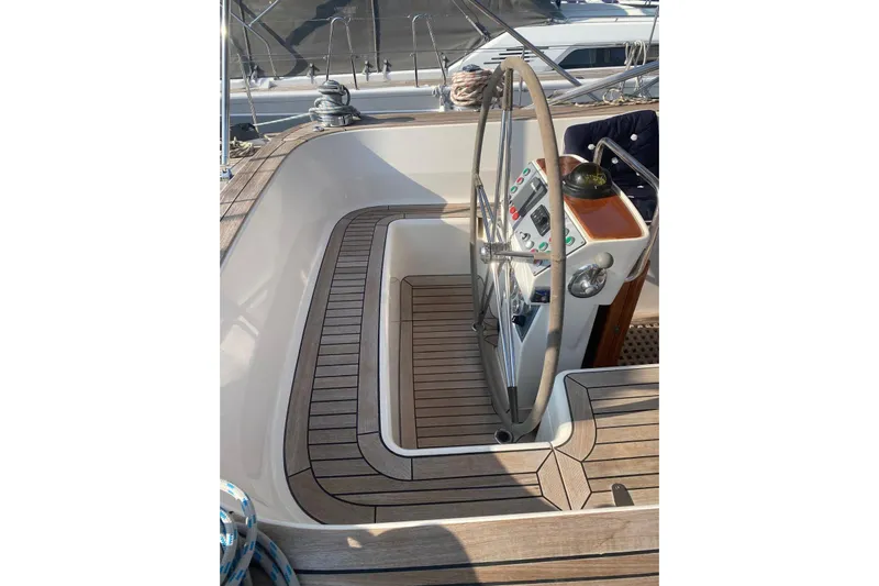 Yacht Photos Pics Cockpit of 2007 Hallberg-Rassy 54 yacht with wooden deck and steering wheel.