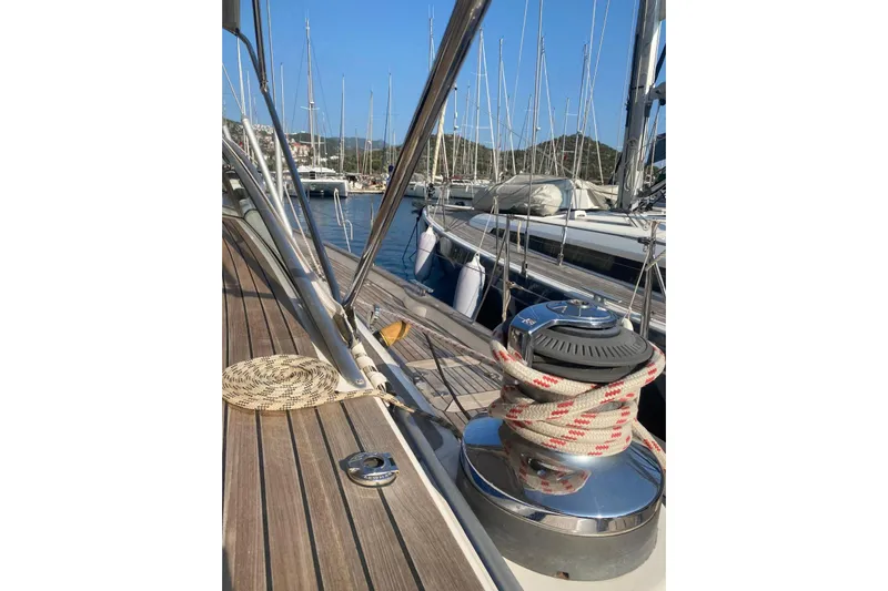  Yacht Photos Pics 2007 Hallberg-Rassy 54 yacht deck with winch and ropes in marina setting.