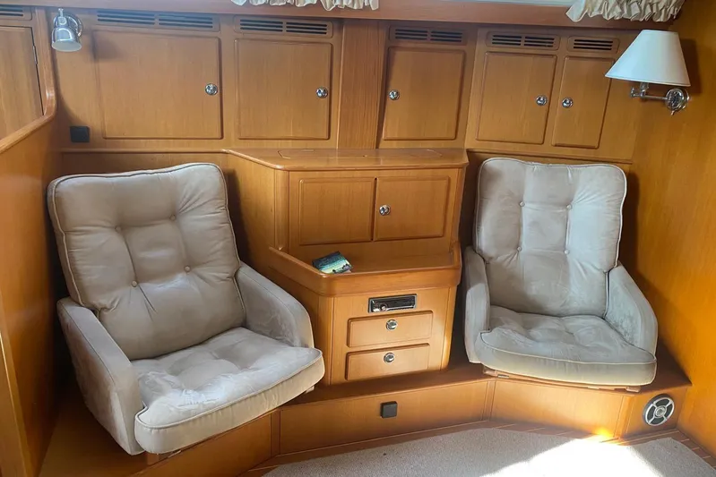  Yacht Photos Pics Luxurious 2007 Hallberg-Rassy 54 yacht interior with plush seating and wooden cabinetry.