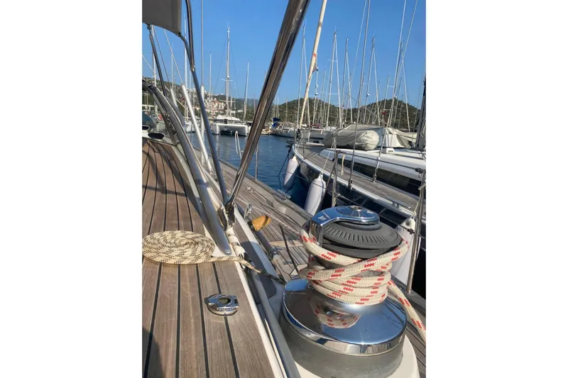  Yacht Photos Pics Deck view of a 2007 Hallberg-Rassy 54 yacht in a marina, showcasing winch and ropes.