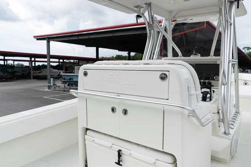  Yacht Photos Pics 2017 SeaVee 340Z boat interior with console and storage, parked under a covered area.
