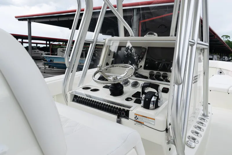  Yacht Photos Pics 2017 SeaVee 340Z boat console with steering wheel and controls, docked under a covered marina.