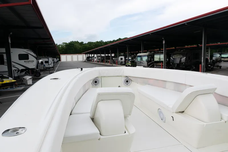  Yacht Photos Pics 2017 SeaVee 340Z boat interior with white seating, parked in a covered storage area.