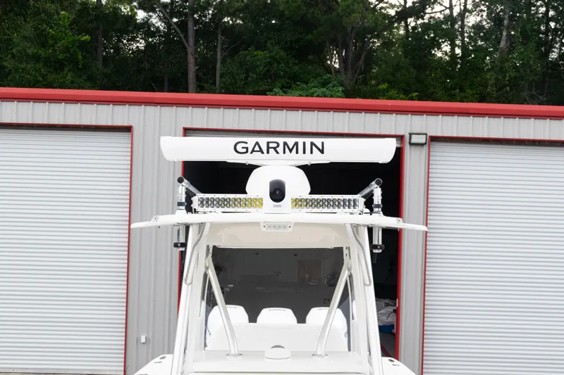  Yacht Photos Pics 2017 SeaVee 340Z boat with Garmin radar, parked near a metal building.