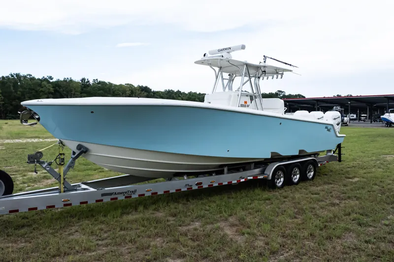 Yacht Photos Pics 2017 SeaVee 340Z boat on trailer, light blue hull, parked on grass.