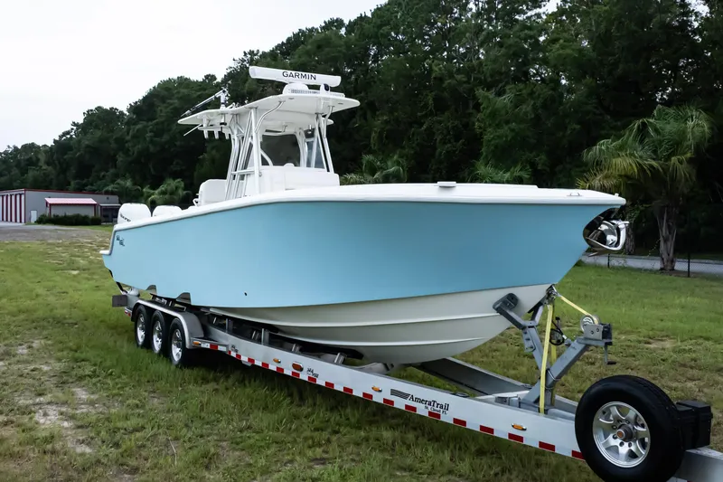  Yacht Photos Pics 2017 SeaVee 340Z boat on trailer, light blue hull, parked on grass.