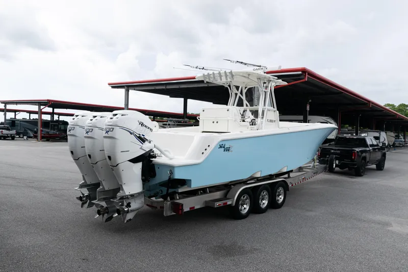  Yacht Photos Pics 2017 SeaVee 340Z boat with triple engines on a trailer in a parking area.