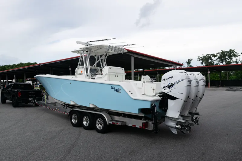  Yacht Photos Pics 2017 SeaVee 340Z boat on trailer with triple outboard engines in parking lot.