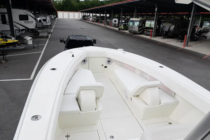  Yacht Photos Pics 2017 SeaVee 340Z boat with white seating, parked in a covered storage area.
