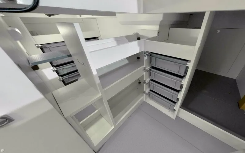  Yacht Photos Pics Manufacturer Provided Image: Interior storage space of 2017 Jeanneau Velasco 43 yacht with shelves and drawers.