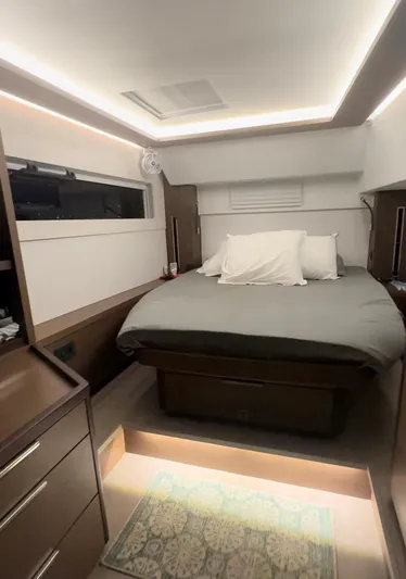  Yacht Photos Pics Interior of 2022 Lagoon 46 yacht cabin with modern bed and ambient lighting.