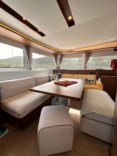  Yacht Photos Pics Interior of 2022 Lagoon 46 catamaran with cozy seating and dining area.