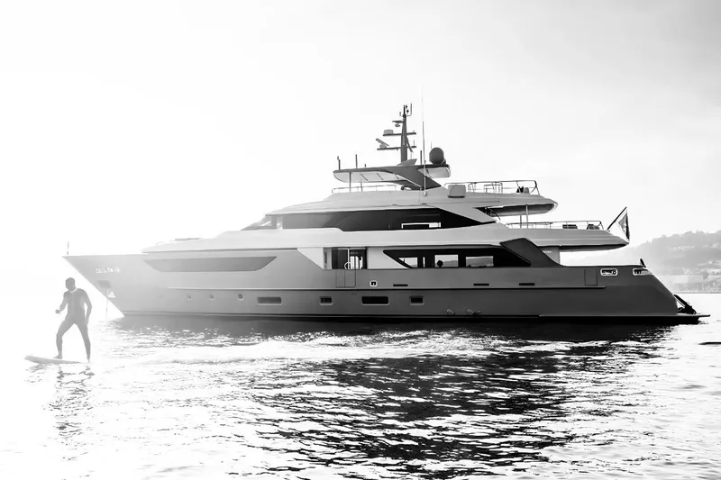  Yacht Photos Pics Sanlorenzo SD126 yacht 2022 with person paddleboarding nearby, in serene waters.