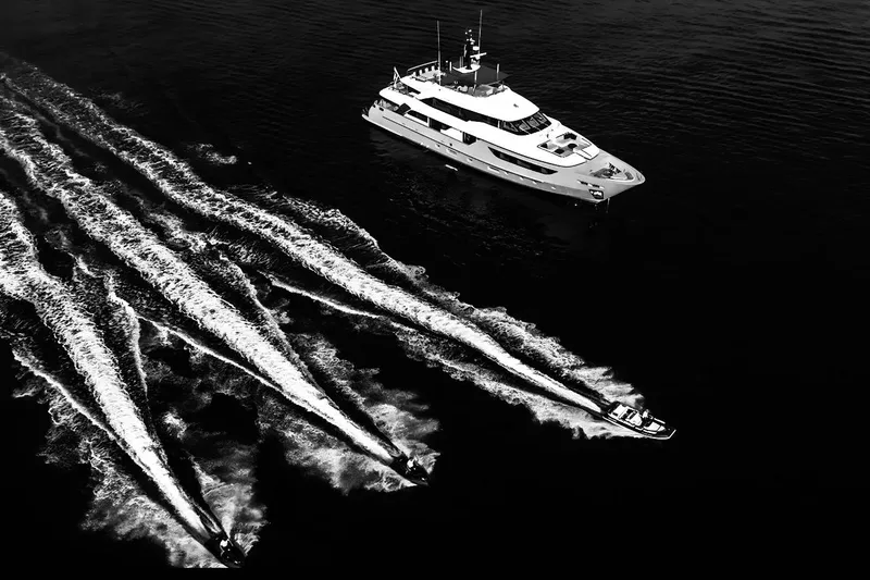  Yacht Photos Pics Aerial view of 2022 Sanlorenzo SD126 yacht with jet skis in motion.