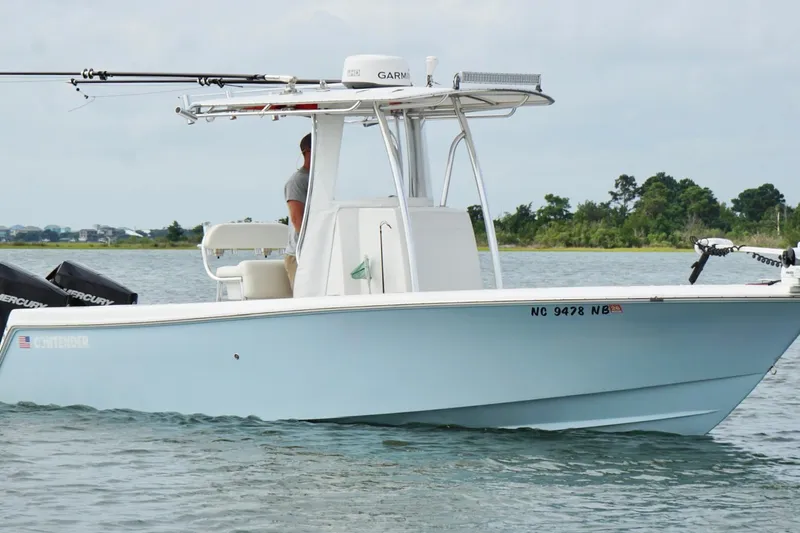  Yacht Photos Pics 2024 Contender 25 Tournament boat on water, featuring dual Mercury engines.