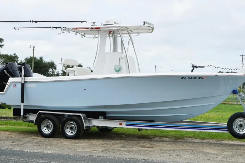  Yacht Photos Pics 2024 Contender 25 Tournament boat on trailer, side view, light blue hull.