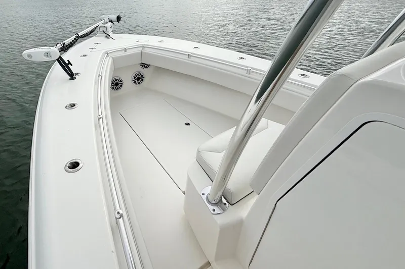  Yacht Photos Pics 2024 Contender 25 Tournament boat, sleek white deck, modern design, on calm water.