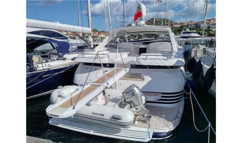  Yacht Photos Pics 2002 Pershing 54 yacht docked at marina with inflatable boat.