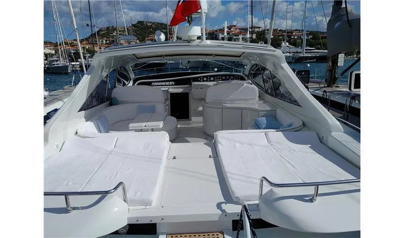  Yacht Photos Pics 2002 Pershing 54 yacht with spacious deck and luxurious seating in marina.