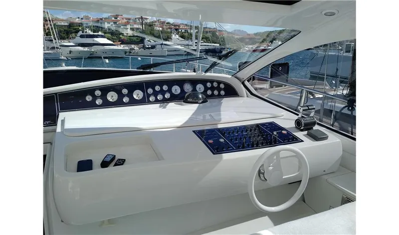  Yacht Photos Pics Cockpit of 2002 Pershing 54 yacht with control panel and steering wheel.