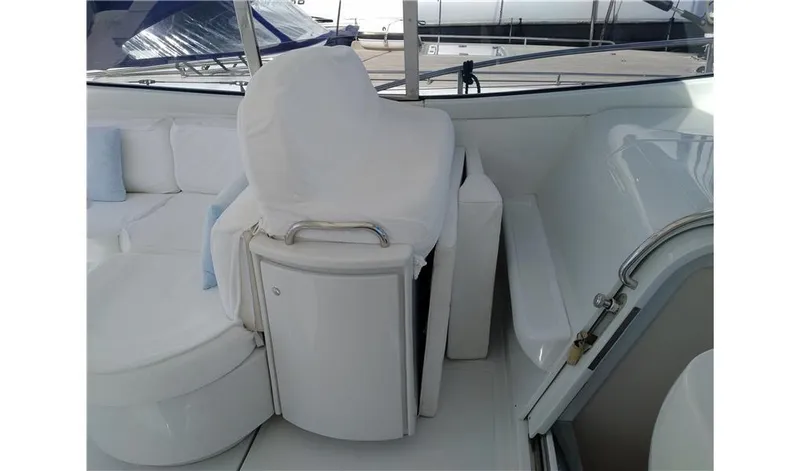  Yacht Photos Pics 2002 Pershing 54 yacht interior with white seating and helm station.