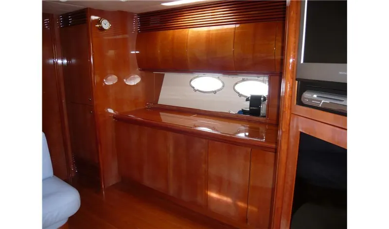 Yacht Photos Pics Luxurious wooden interior of a 2002 Pershing 54 yacht cabin with elegant cabinetry.