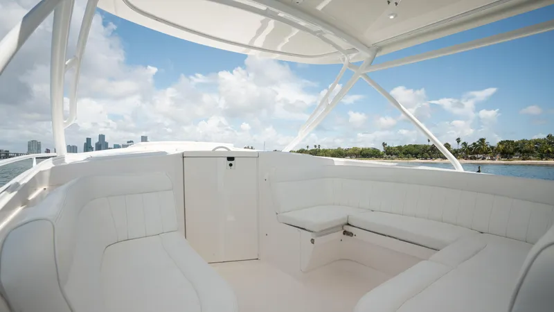  Yacht Photos Pics 2013 Intrepid 400 Cuddy boat interior with white seating, ocean view, and blue sky.