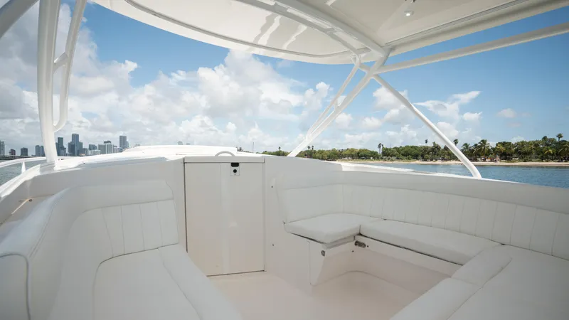  Yacht Photos Pics 2013 Intrepid 400 Cuddy boat interior with white seating, ocean view, and city skyline.