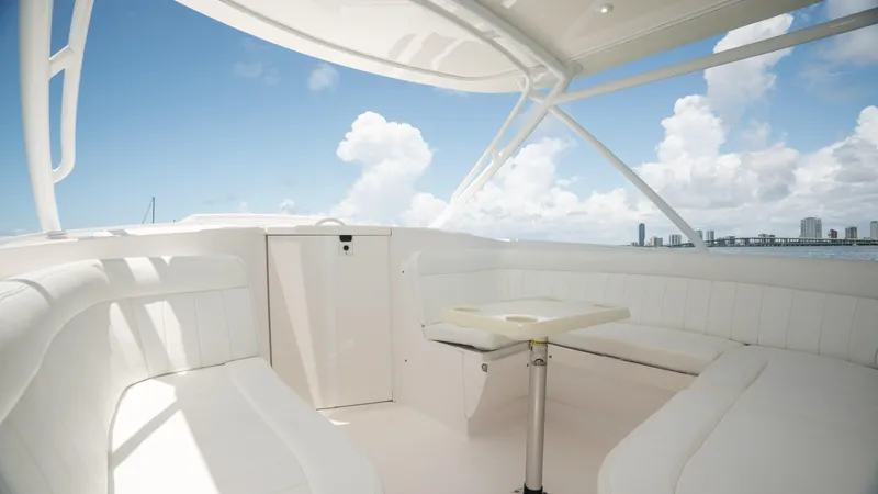  Yacht Photos Pics Luxurious 2013 Intrepid 400 Cuddy boat interior with white seating and table, ocean view.
