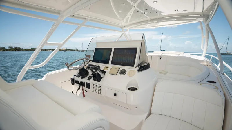  Yacht Photos Pics 2013 Intrepid 400 Cuddy boat interior with modern navigation equipment and white seating.