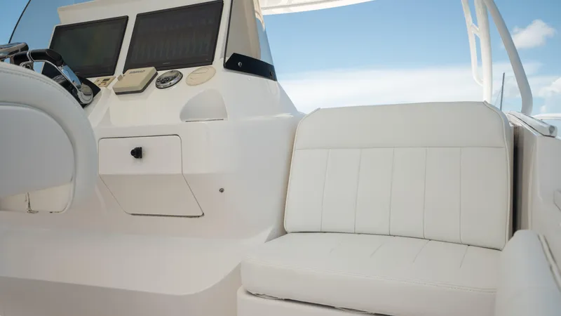  Yacht Photos Pics 2013 Intrepid 400 Cuddy boat interior with white seating and control panel.