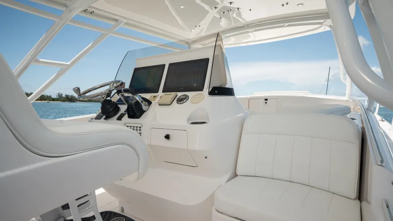  Yacht Photos Pics 2013 Intrepid 400 Cuddy boat interior with helm and seating, featuring modern controls.