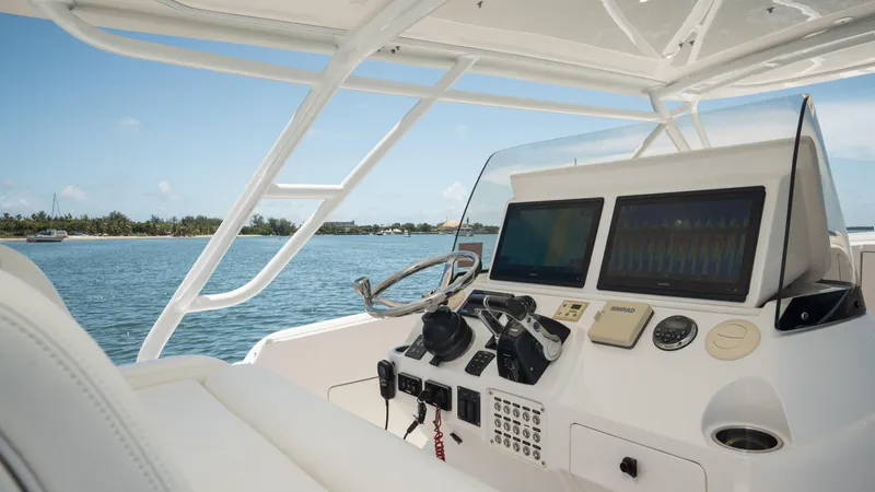  Yacht Photos Pics Intrepid 400 Cuddy 2013 helm with dual screens, steering wheel, and controls on open water.