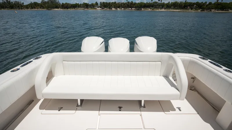  Yacht Photos Pics 2013 Intrepid 400 Cuddy boat with white seating and triple outboard motors on a calm lake.