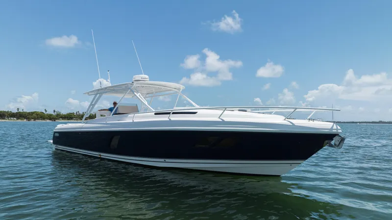  Yacht Photos Pics 2013 Intrepid 400 Cuddy boat on calm water under blue sky.