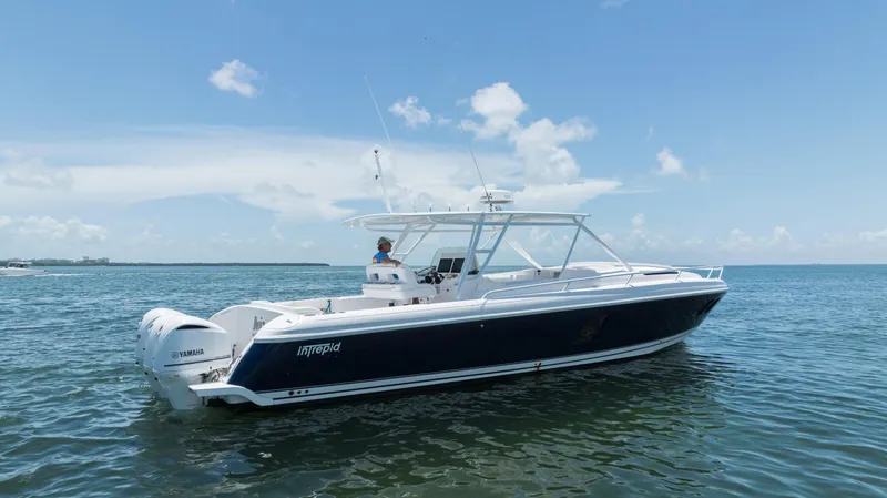  Yacht Photos Pics 2013 Intrepid 400 Cuddy boat on calm water under blue sky.