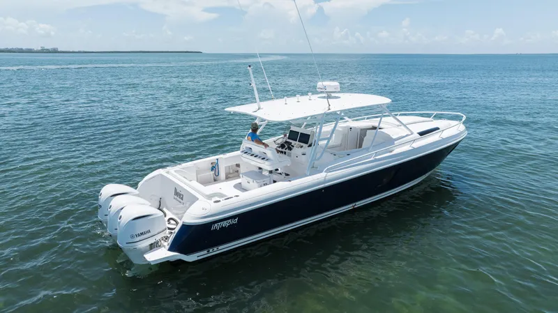  Yacht Photos Pics 2013 Intrepid 400 Cuddy boat on calm ocean waters.