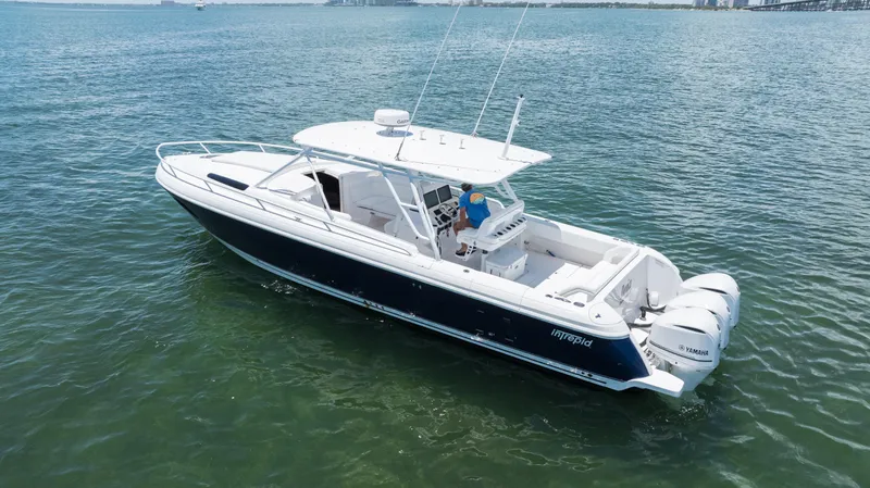  Yacht Photos Pics 2013 Intrepid 400 Cuddy boat on calm water, featuring sleek design and powerful engines.