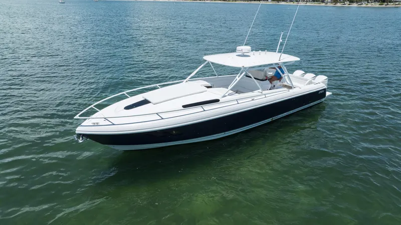  Yacht Photos Pics 2013 Intrepid 400 Cuddy boat on calm water, side view.