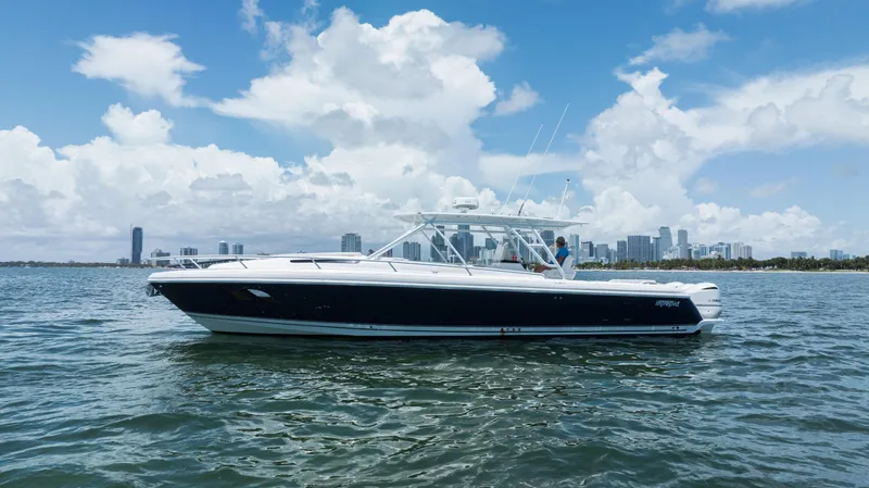  Yacht Photos Pics 2013 Intrepid 400 Cuddy boat on water with city skyline background.