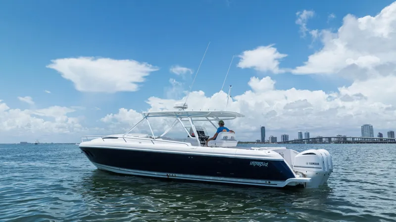  Yacht Photos Pics 2013 Intrepid 400 Cuddy boat on calm water under blue sky.
