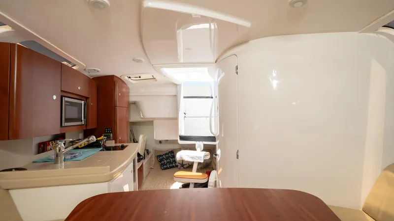  Yacht Photos Pics Interior of 2013 Intrepid 400 Cuddy boat with modern kitchen and seating area.