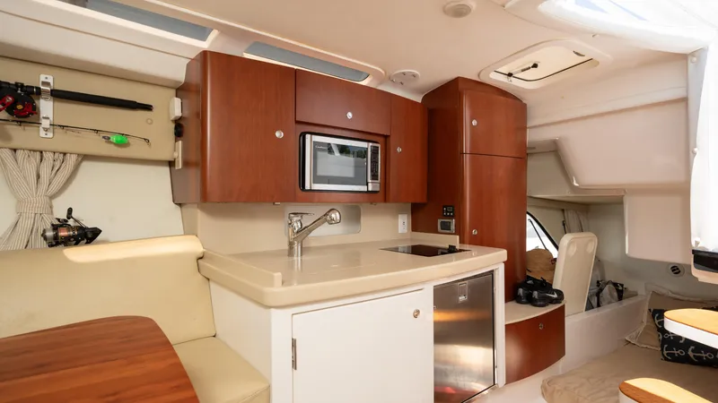  Yacht Photos Pics Interior of 2013 Intrepid 400 Cuddy boat with kitchenette and seating area.