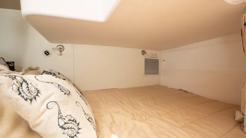  Yacht Photos Pics Cozy cabin interior of 2013 Intrepid 400 Cuddy with comfortable bedding.