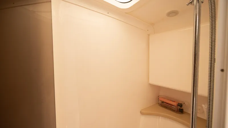  Yacht Photos Pics 2013 Intrepid 400 Cuddy interior cabin with shower and storage space.