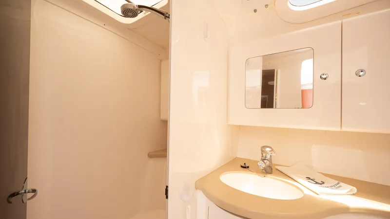  Yacht Photos Pics 2013 Intrepid 400 Cuddy bathroom with shower, sink, and mirror.