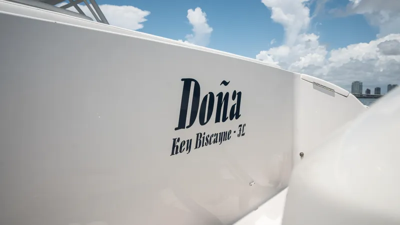  Yacht Photos Pics Intrepid 400 Cuddy 2013 boat with "Doña" name, Key Biscayne, FL, clear sky background.
