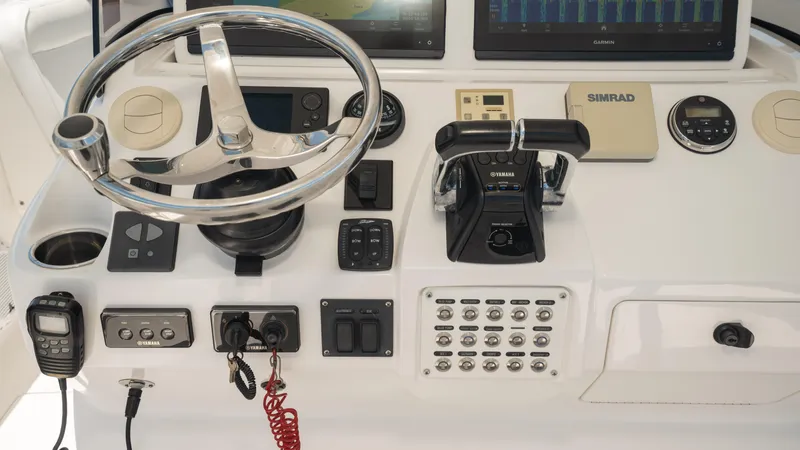  Yacht Photos Pics 2013 Intrepid 400 Cuddy helm with steering wheel and navigation controls.